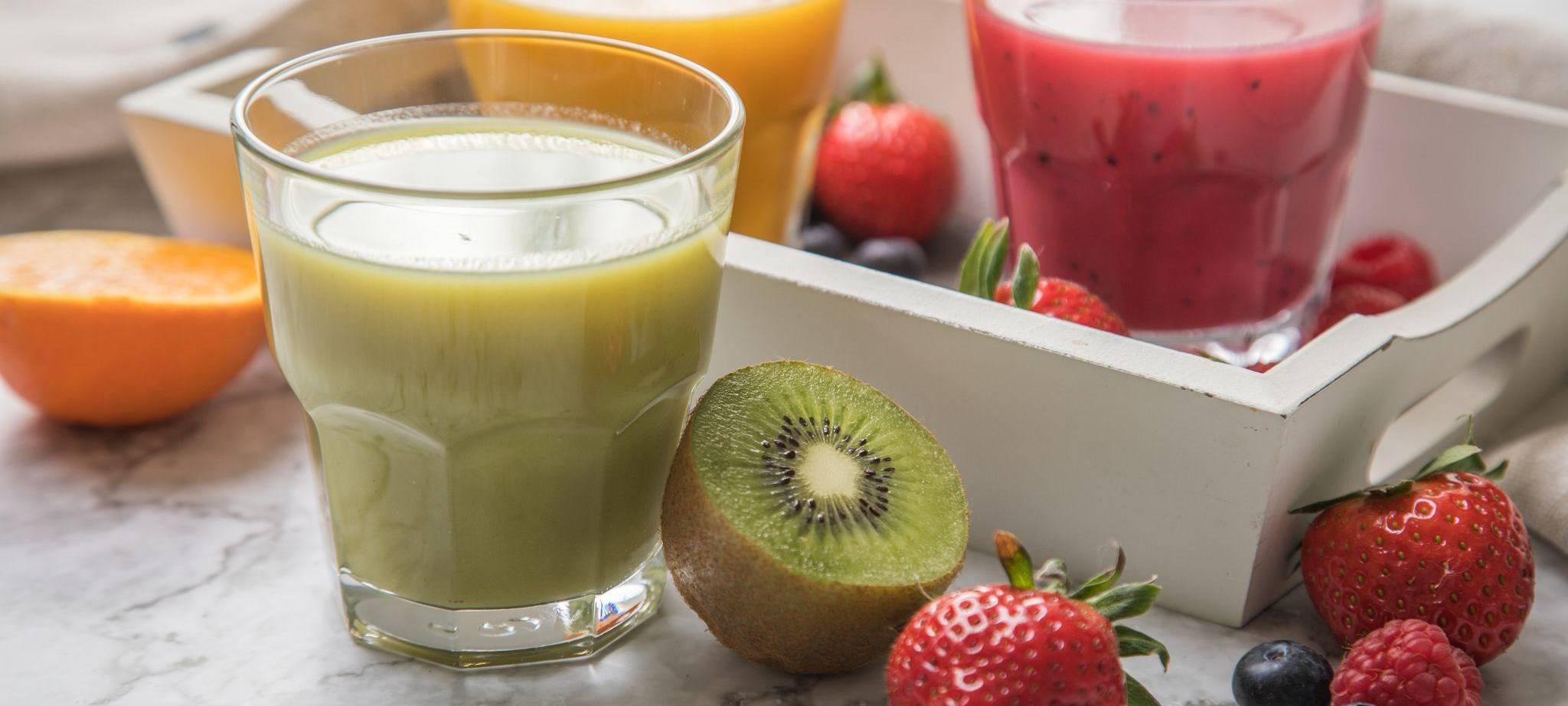 Mehrere Gläser mit frisch gepresstem Fruchtsaft